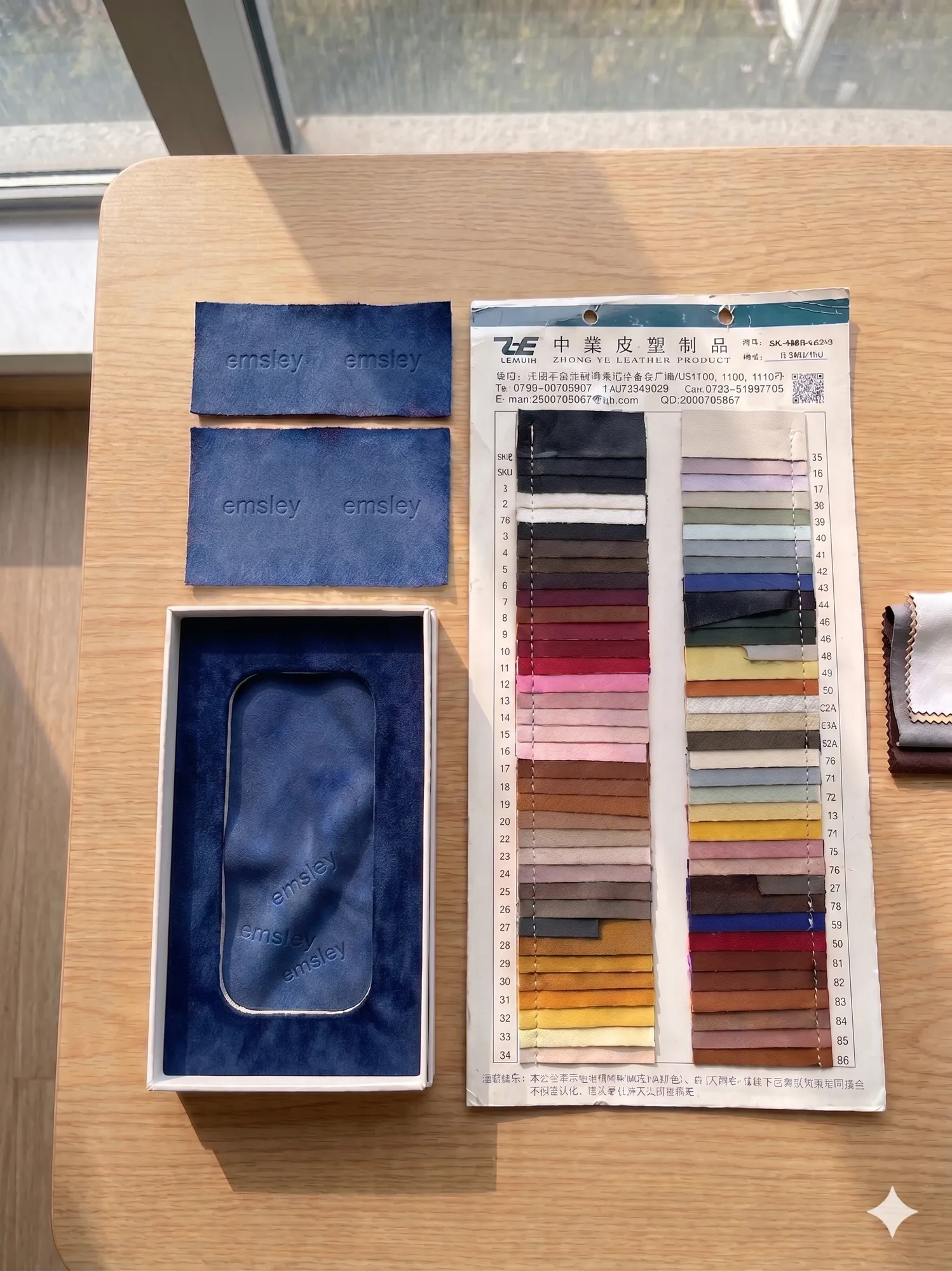 Acetate material swatches arranged on a work surface.