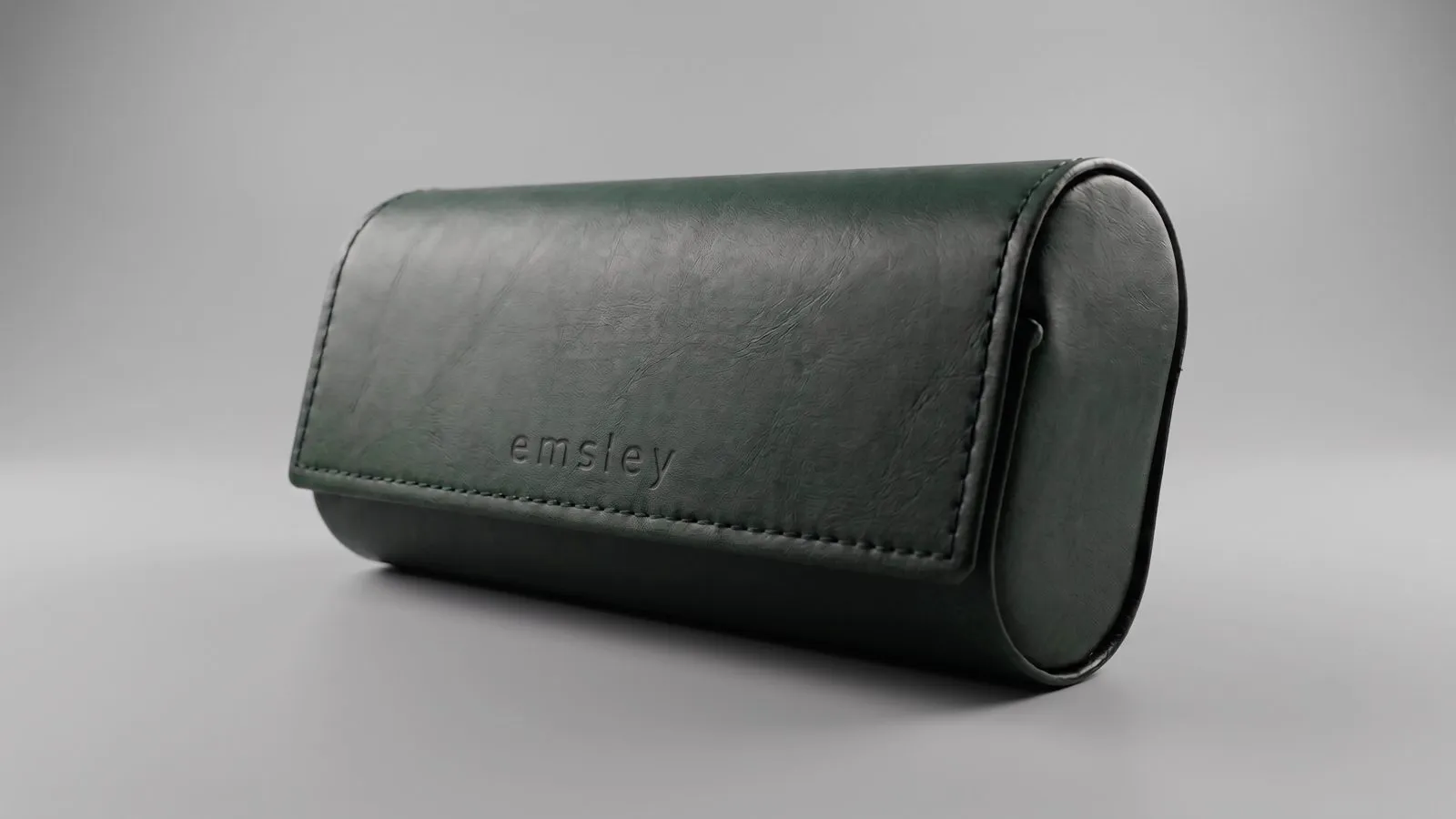 Green leather roll case, blind-embossed.