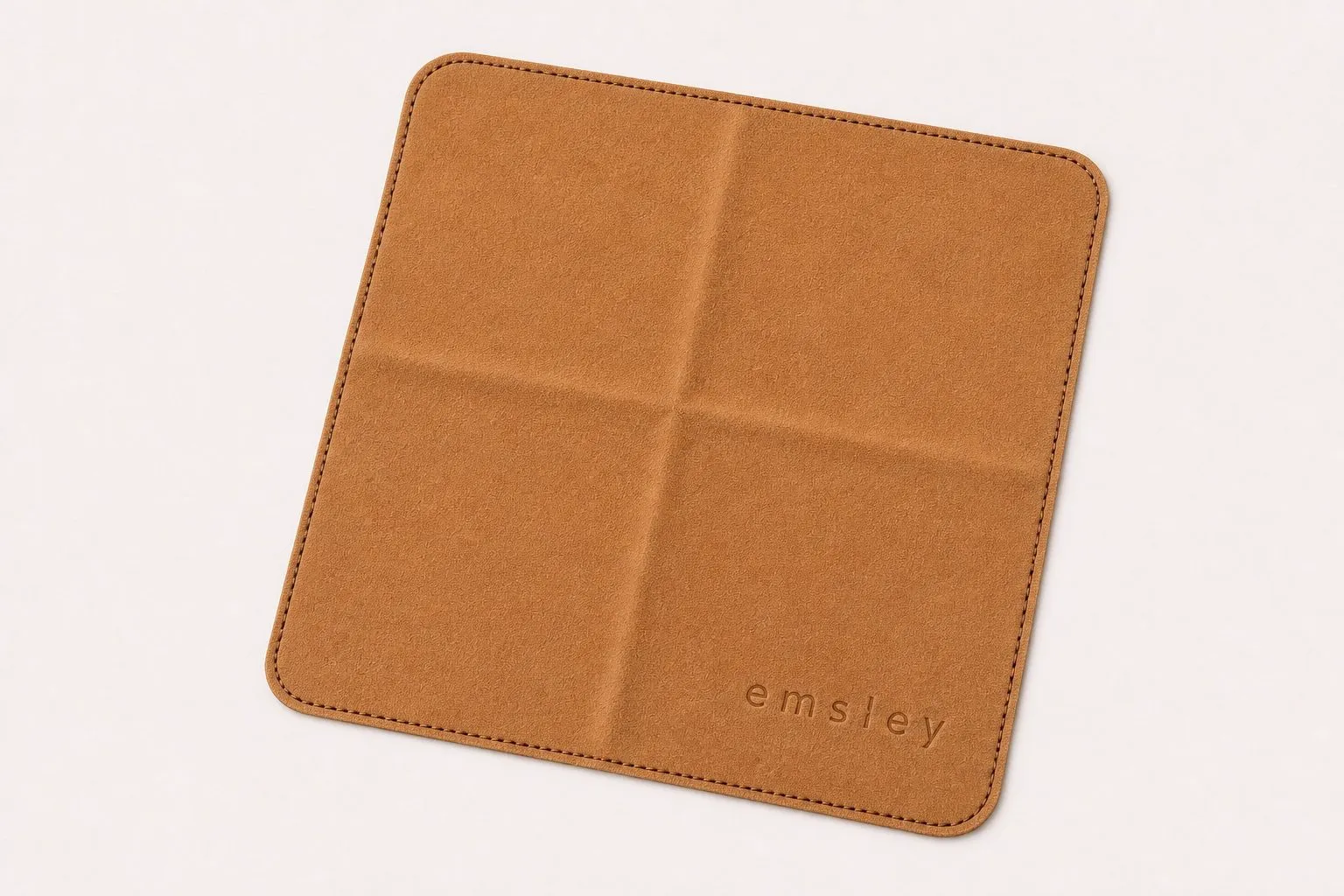 Warm camel microfibre cloth with embossed mark.