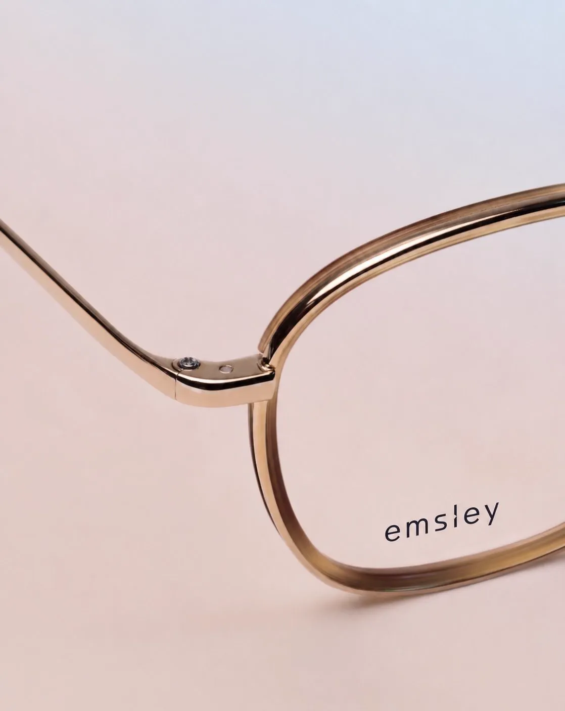 Lens edge and rose-gold rim with engraved branding.